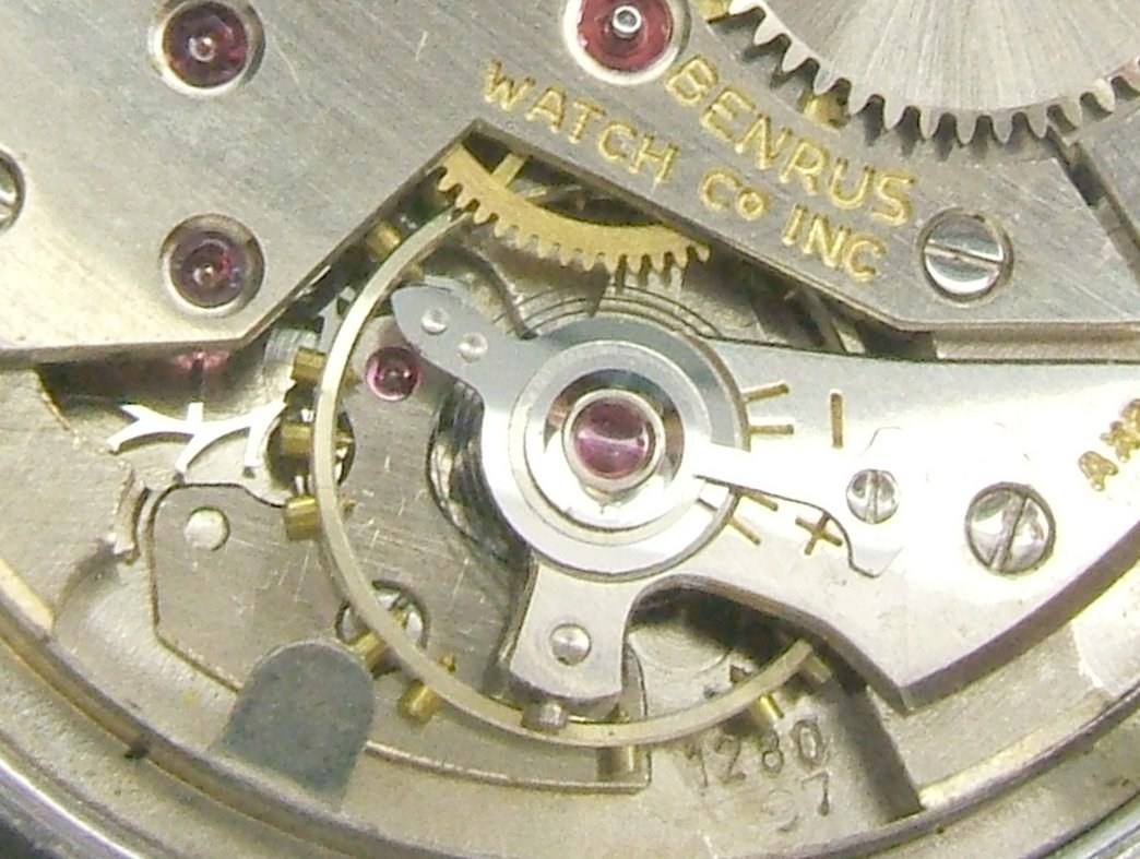 Benrus watch balance wheel and bridge.