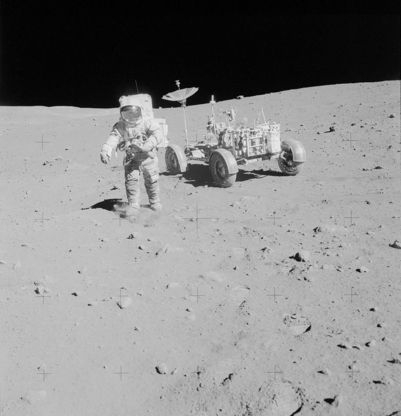 Astronaut Dave Scott on the lunar surface beside the lunar rover during Apollo 15.