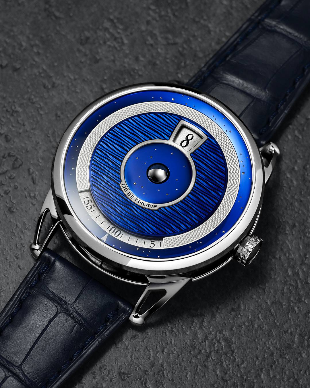 Top-down view of the De Bethune DB25 Digitale blued titanium dial with moonphase sphere and jumping hour aperture