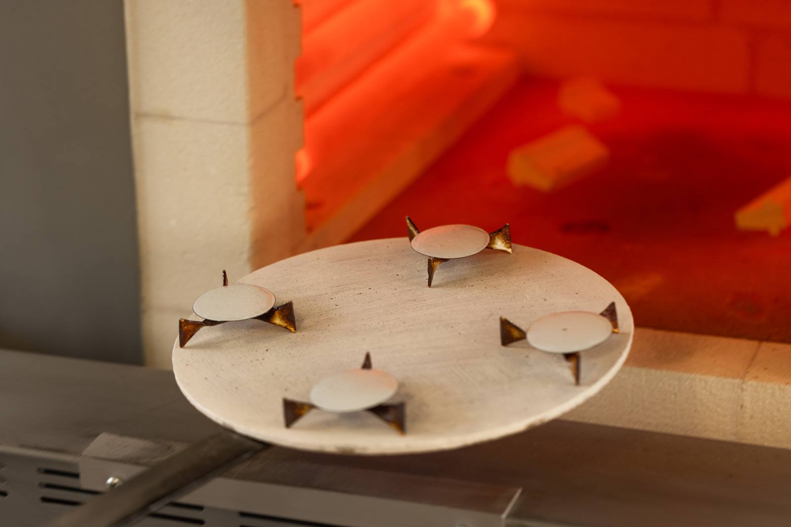 Grand feu enamel dials on the firing tray entering the kiln