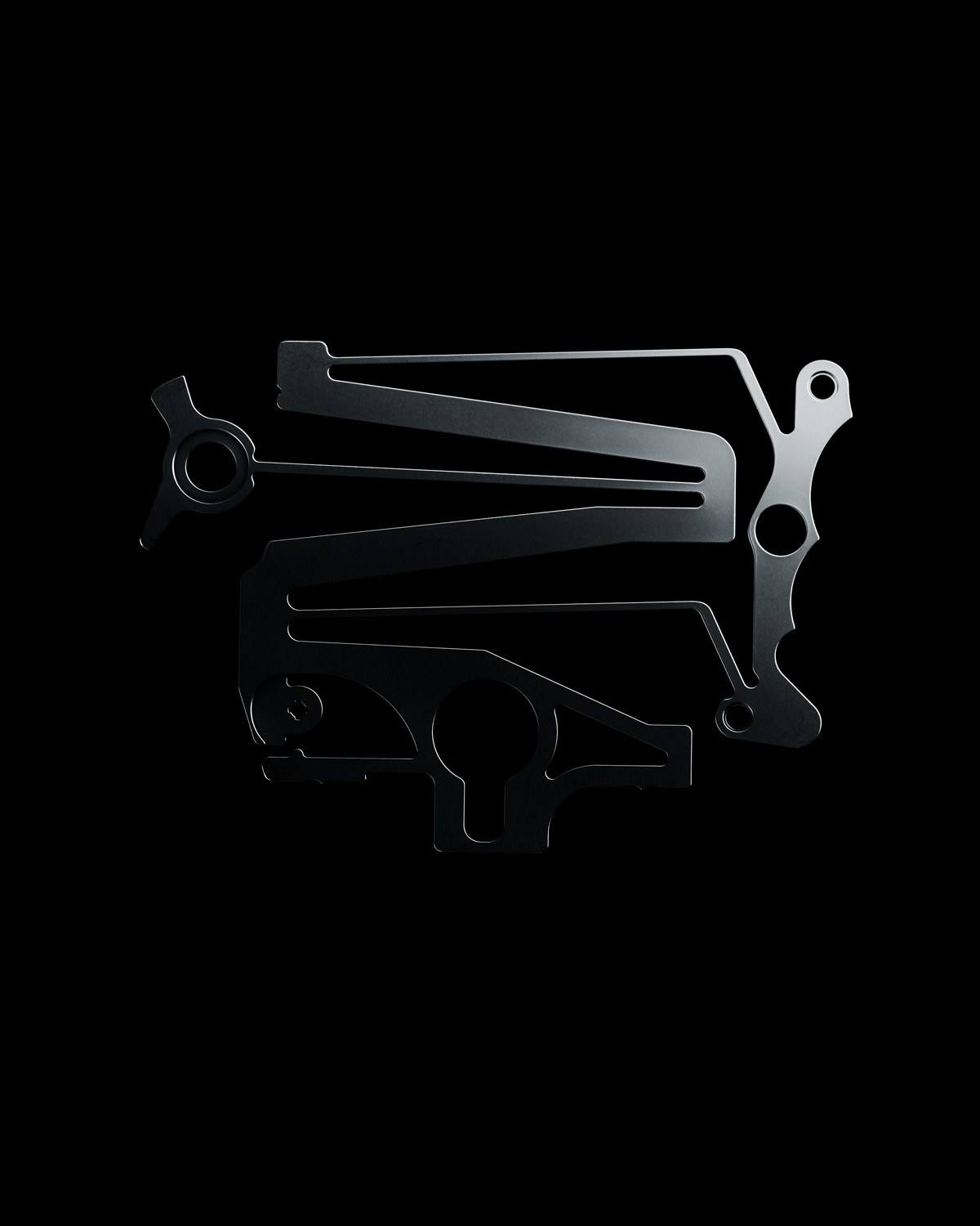 The two flexible bistable components of TAG Heuer's calibre TH80-00, the LIGA-milled compliant mechanism that replaces the levers, cams and column wheel of a conventional chronograph.