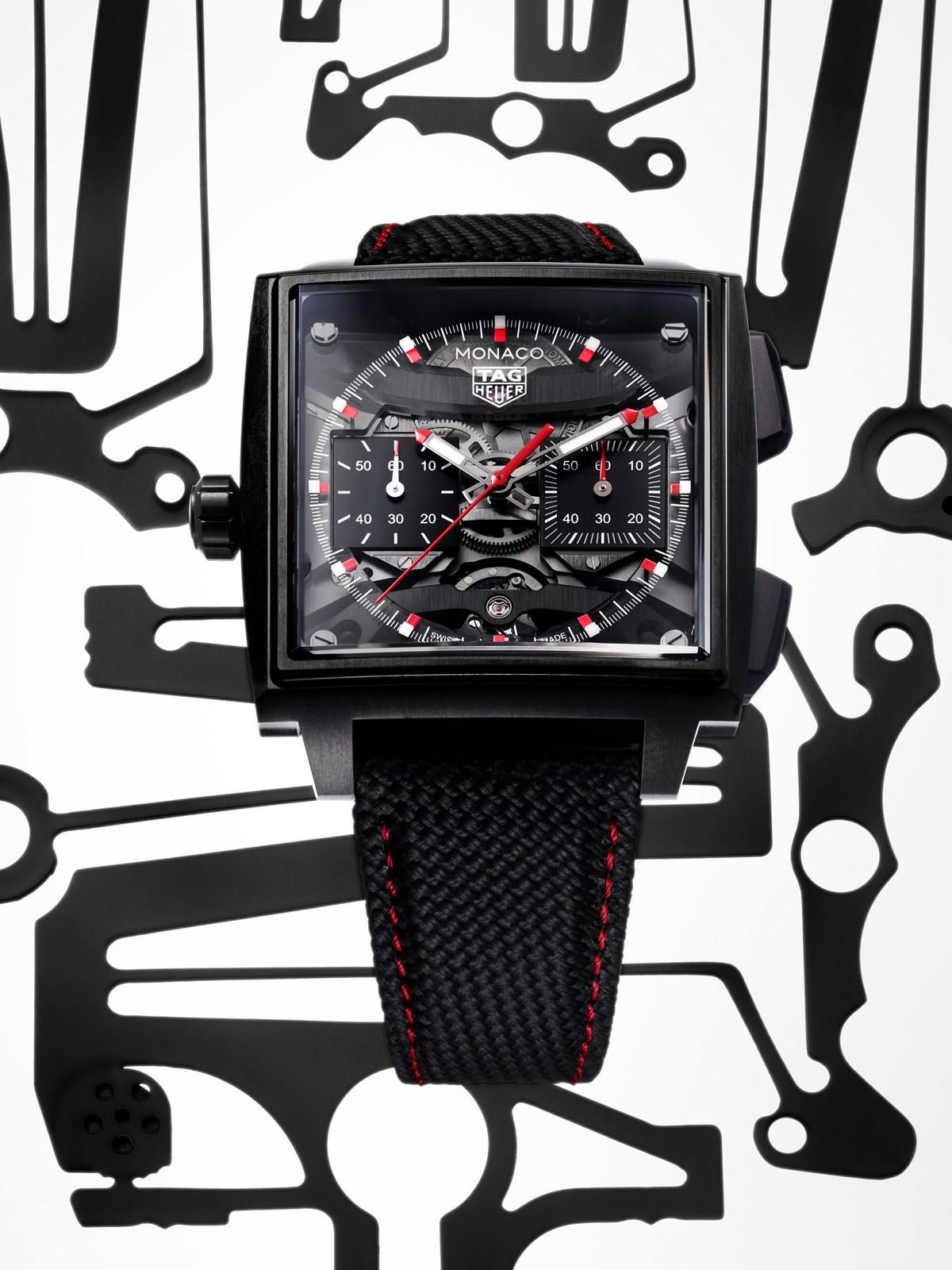 The TAG Heuer Monaco Evergraph in black DLC titanium, its transparent dial exposing the reversed TH80-00 movement and red chronograph hands.