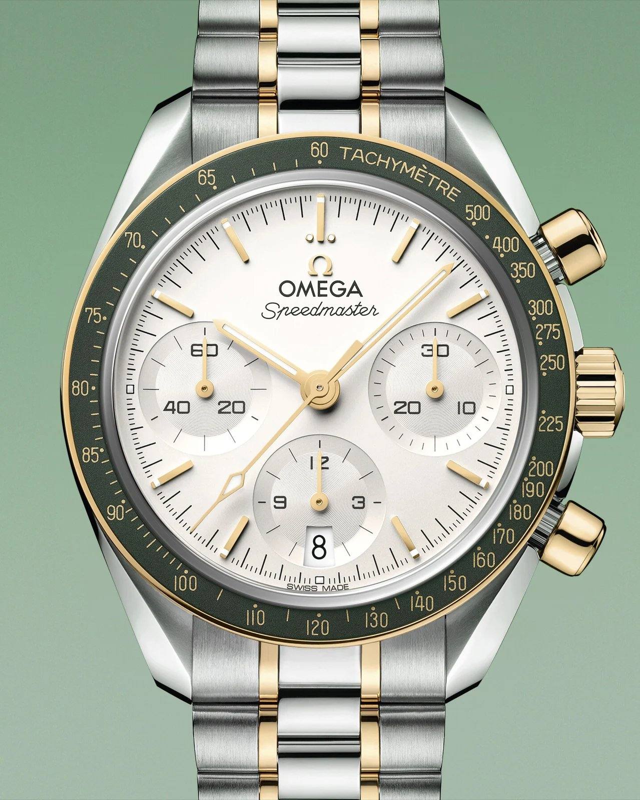 Omega Speedmaster 38 reference 324.20.38.50.02.001: silvery opaline dial, green aluminium bezel, Moonshine Gold two-tone bracelet