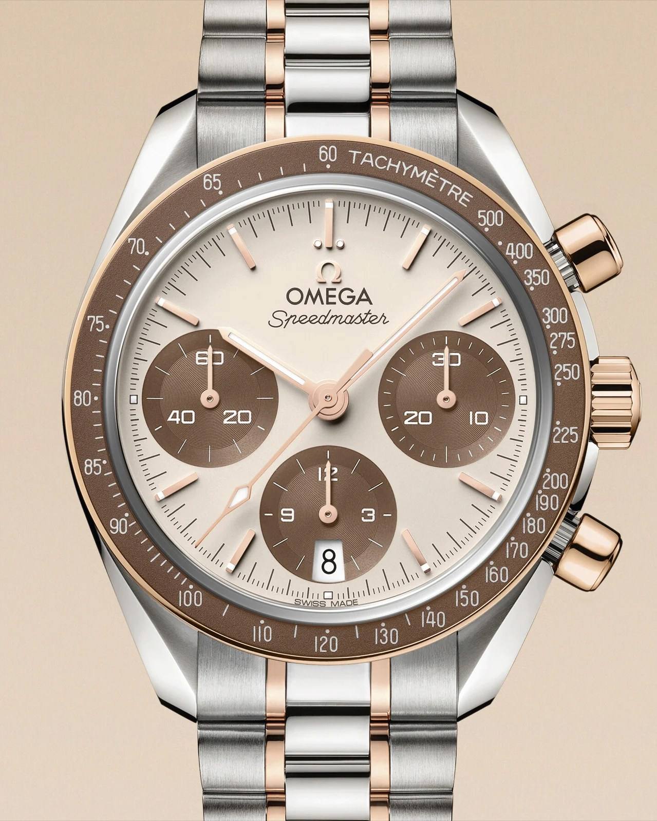 Omega Speedmaster 38 reference 324.20.38.50.02.002: ivory dial with brown subdials, brown aluminium bezel, Sedna Gold two-tone bracelet