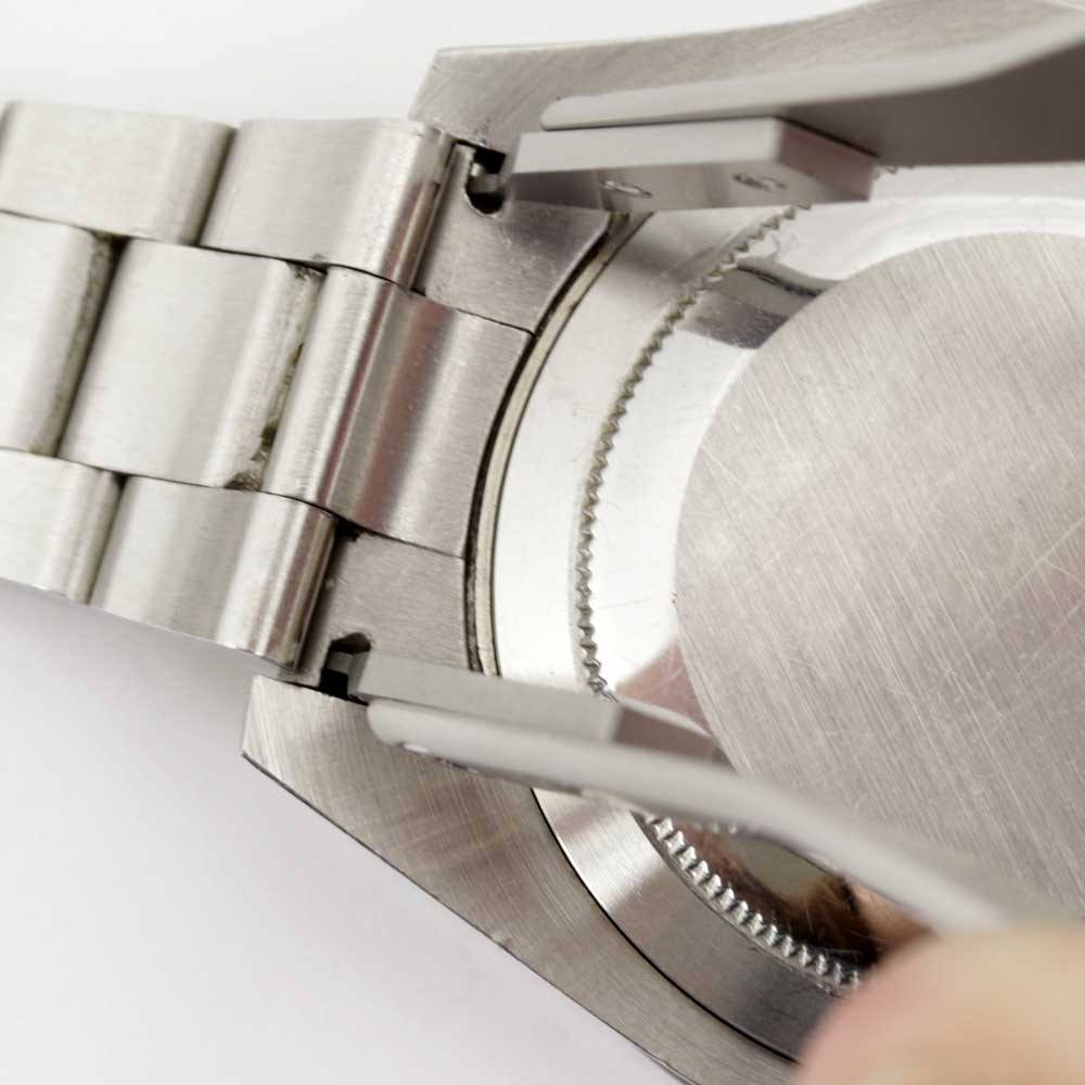 Bergeon 7825 spring bar tweezers gripping a spring bar at a watch case lug.