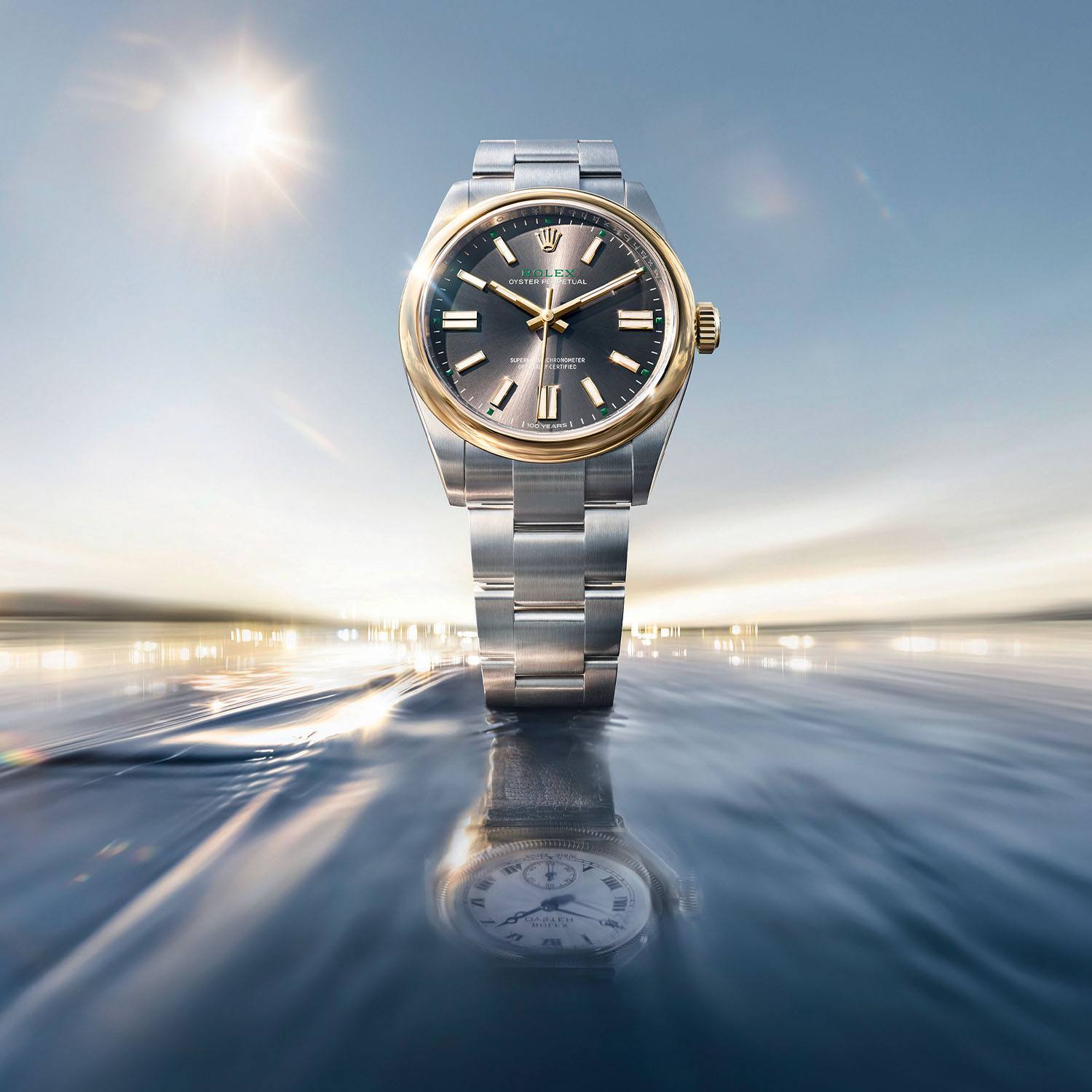 Rolex Oyster Perpetual 41 centenary edition in yellow Rolesor, front view, slate sunray dial with 100 Years mark at six o'clock