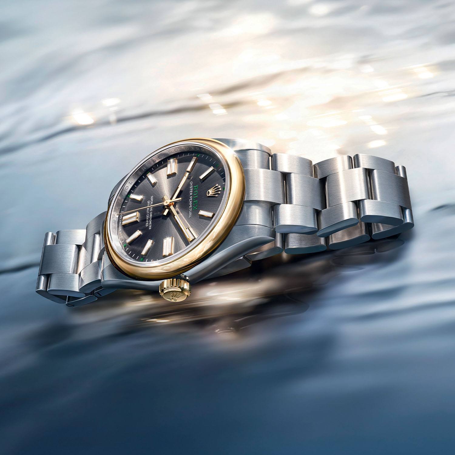 Three-quarter view of the Rolex Oyster Perpetual 41 centenary edition showing the gold bezel and steel Oyster bracelet