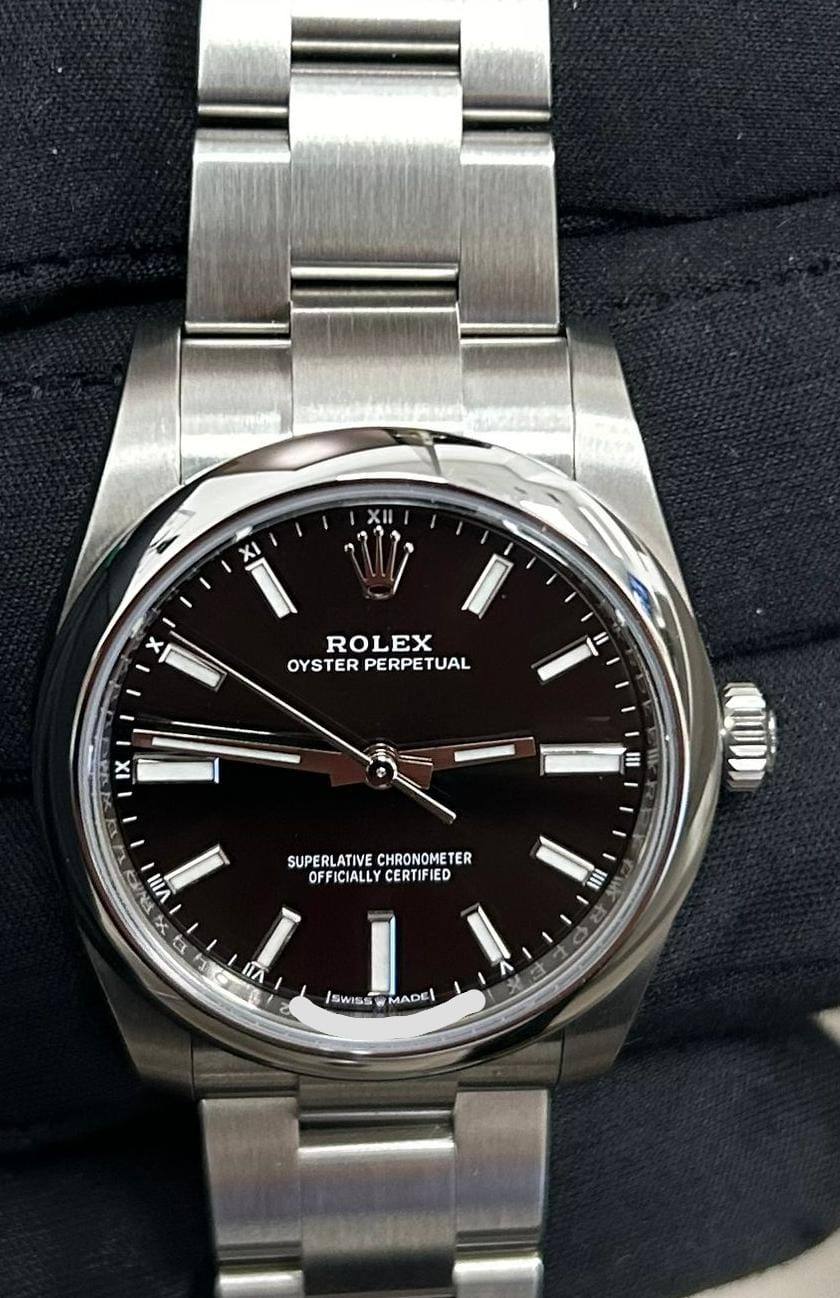 Rolex Oyster Perpetual wristwatch with black dial and Oyster bracelet.
