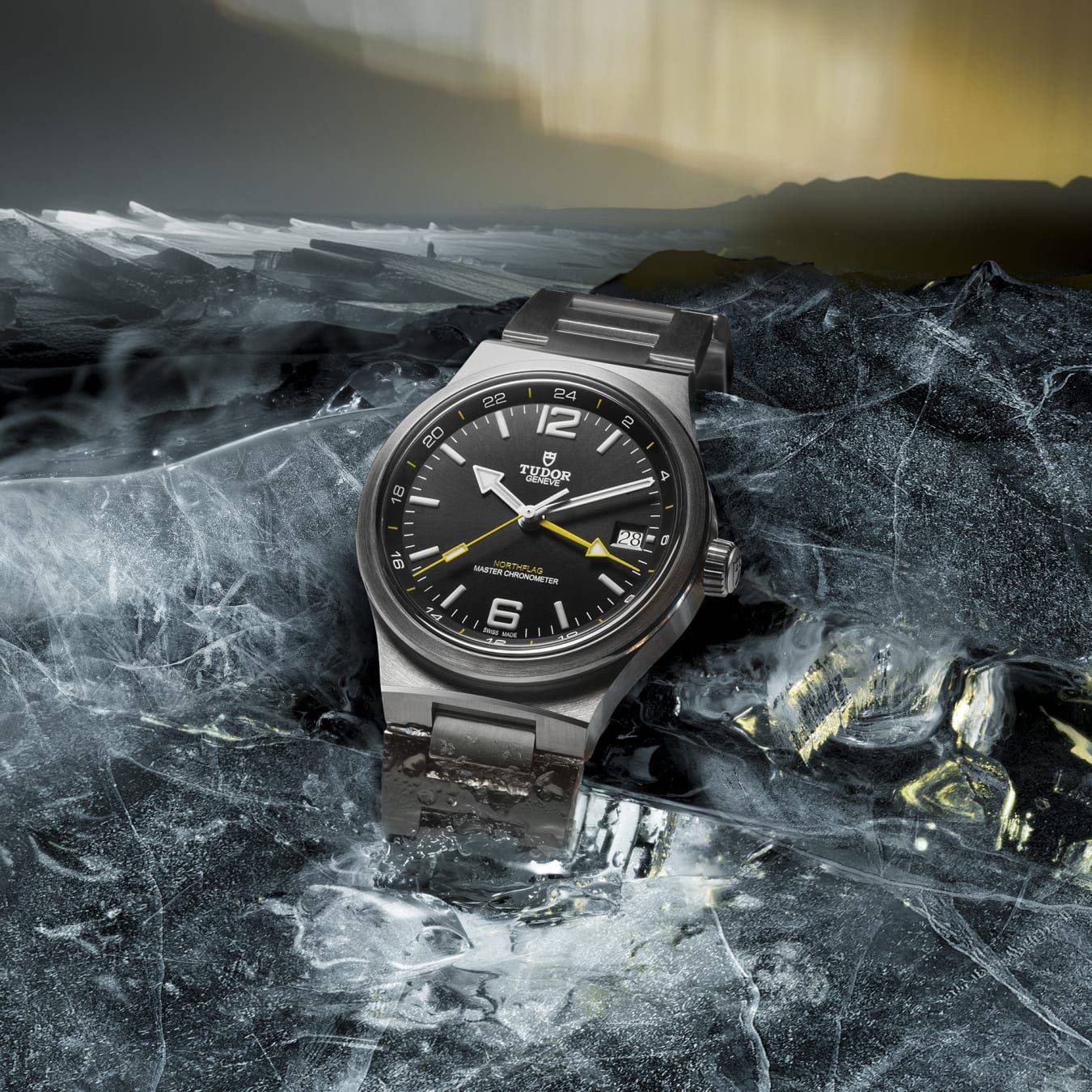 Tudor Northflag GMT with black sunburst dial, yellow GMT hand and integrated steel bracelet.